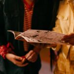 person holding white printer paper